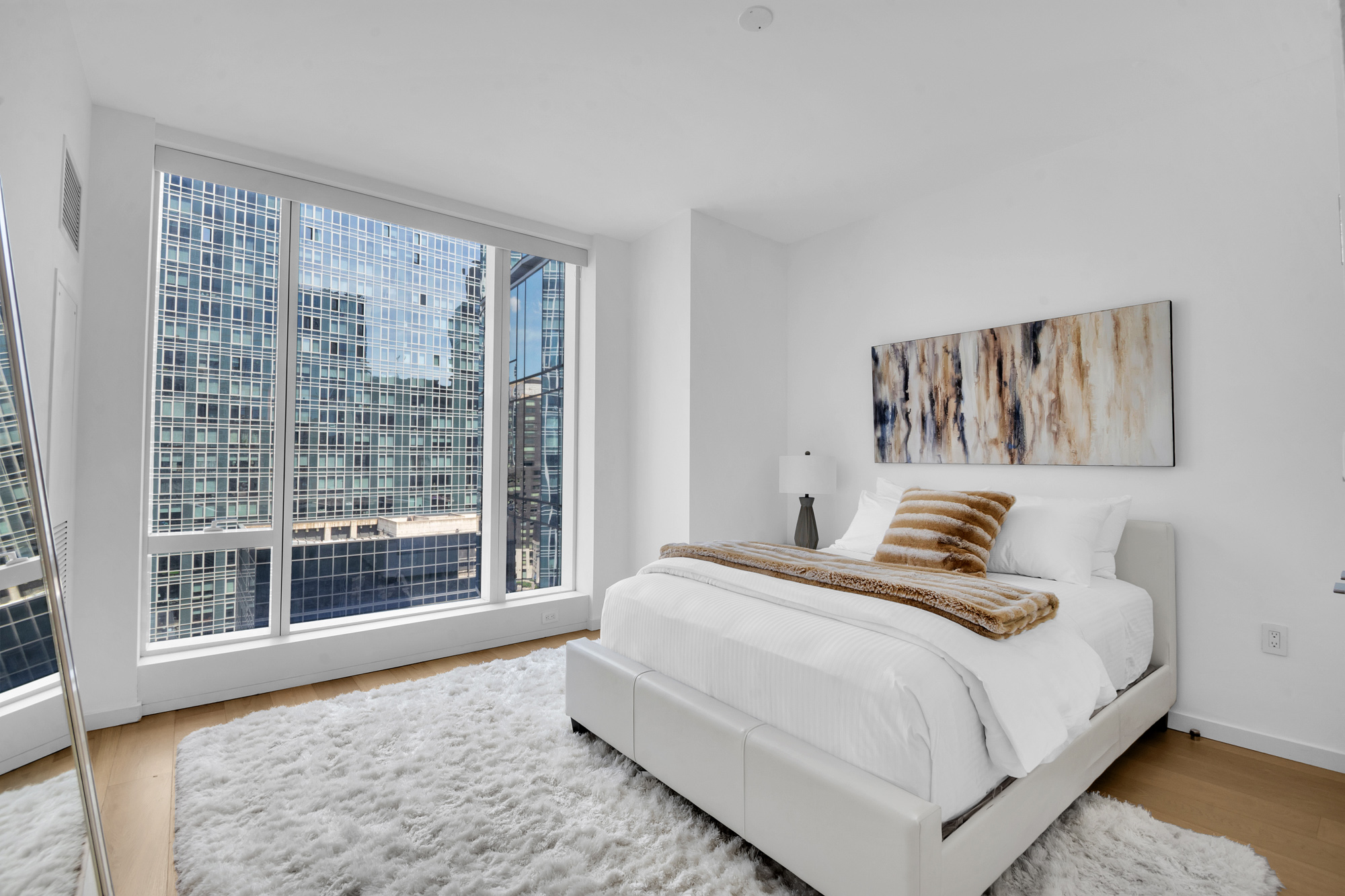 1 West End Avenue, Unit 16L Manhattan, NY 10069 - Photo 5 of 11 a bedroom with a bed and a large window