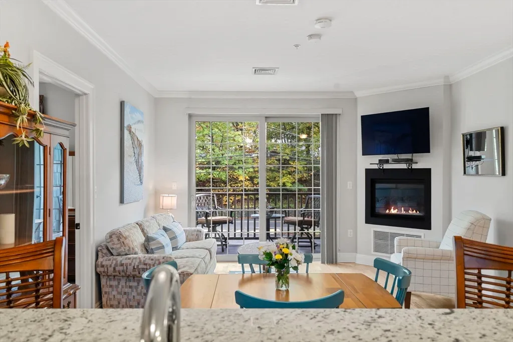 a living room with fireplace furniture and a flat screen tv