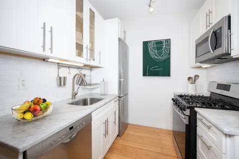 a kitchen that has a sink and a stove