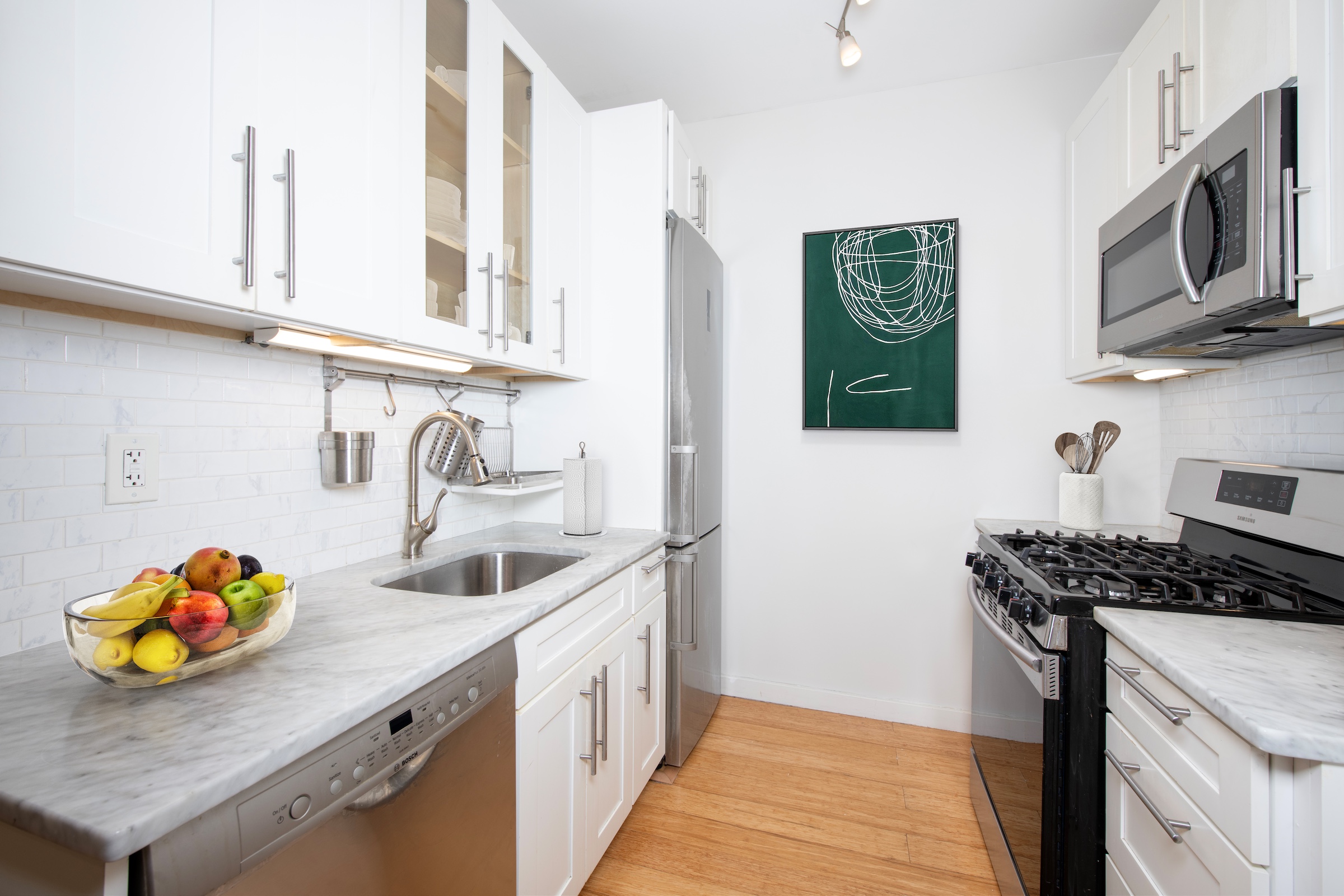 209 West 118th Street, Unit 4D New York, NY 10026 - Photo 2 of 7 a kitchen that has a sink and a stove