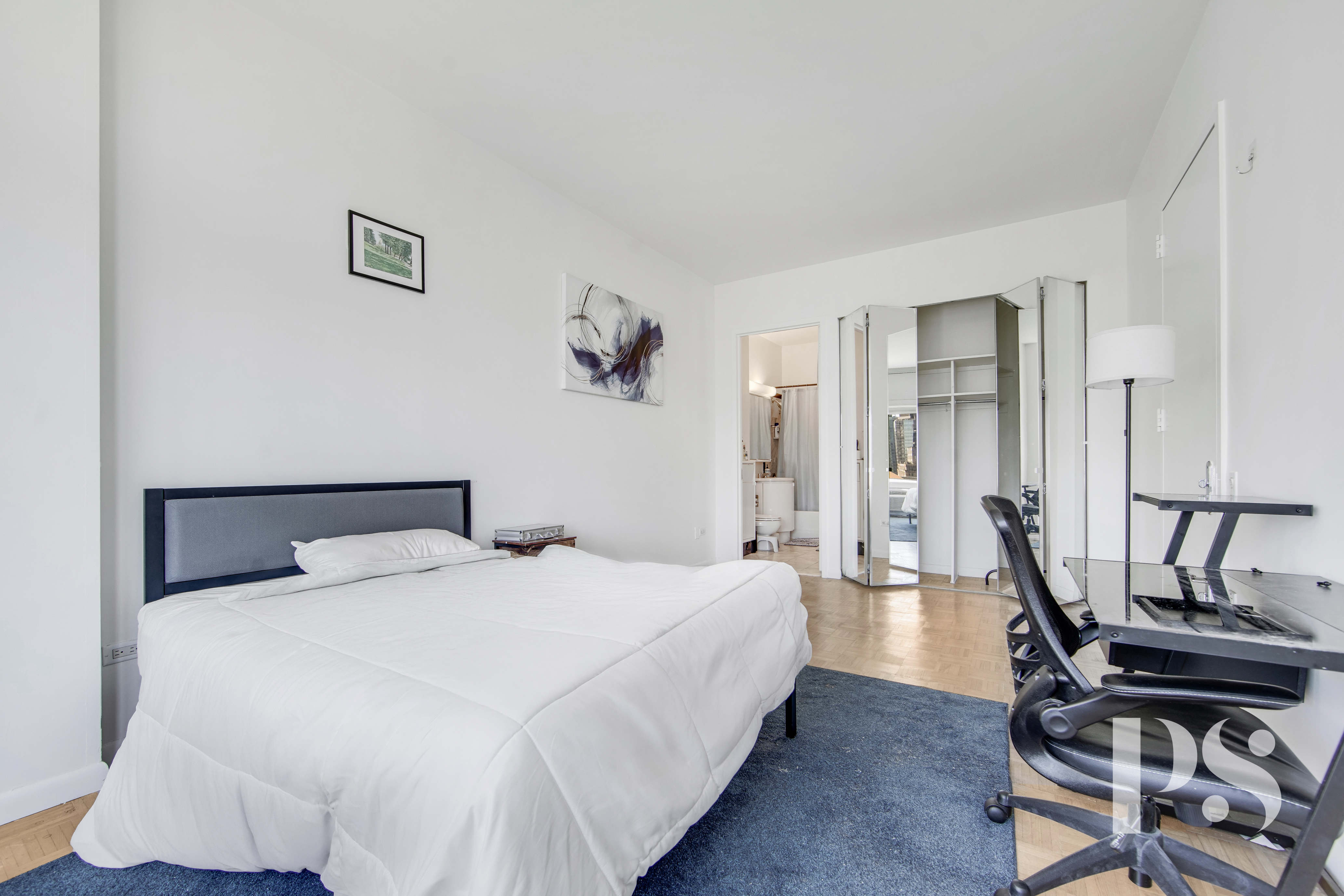 200 East 32nd Street, Unit 33C Manhattan, NY 10016 - Photo 7 of 12 a bedroom with a bed and furniture