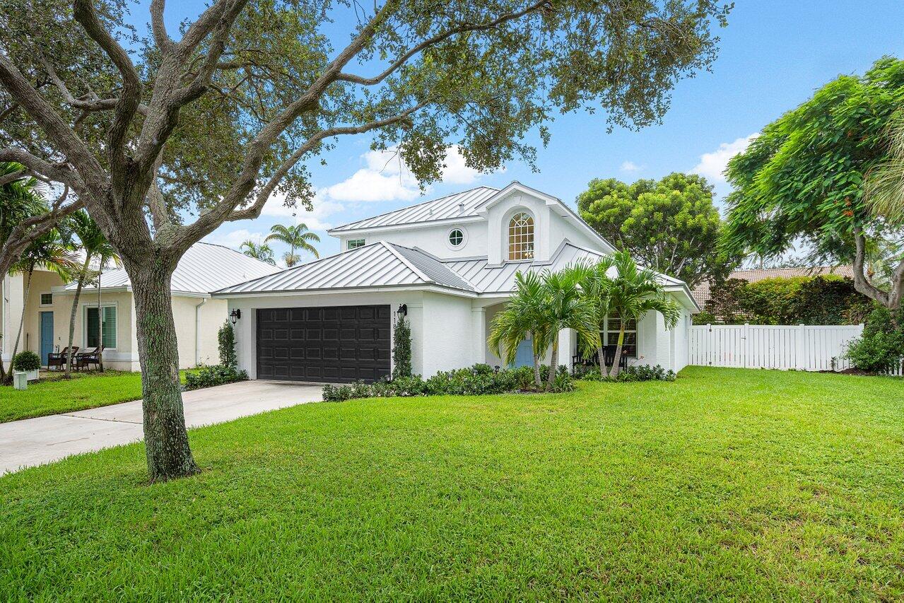1182 Canoe Point Delray Beach, FL 33444 - Photo 2 of 46 a front view of house with yard and green space