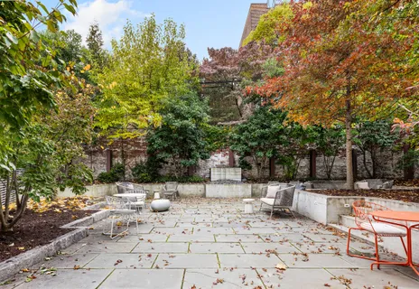 a view of a patio with a wooden fence