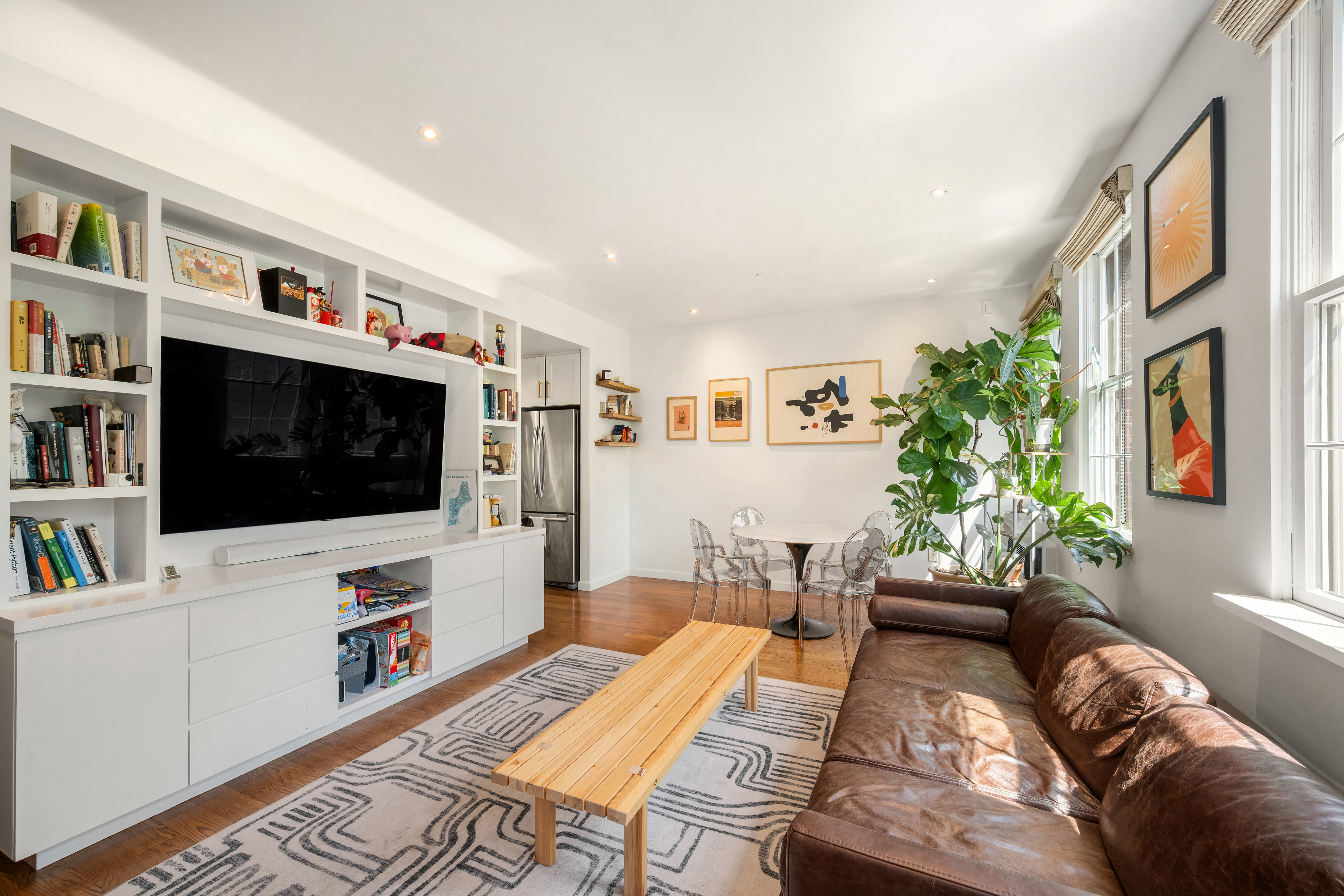 407 East 12th Street, Unit 3FE Manhattan, NY 10009 - Photo 5 of 11 a living room with furniture and a flat screen tv