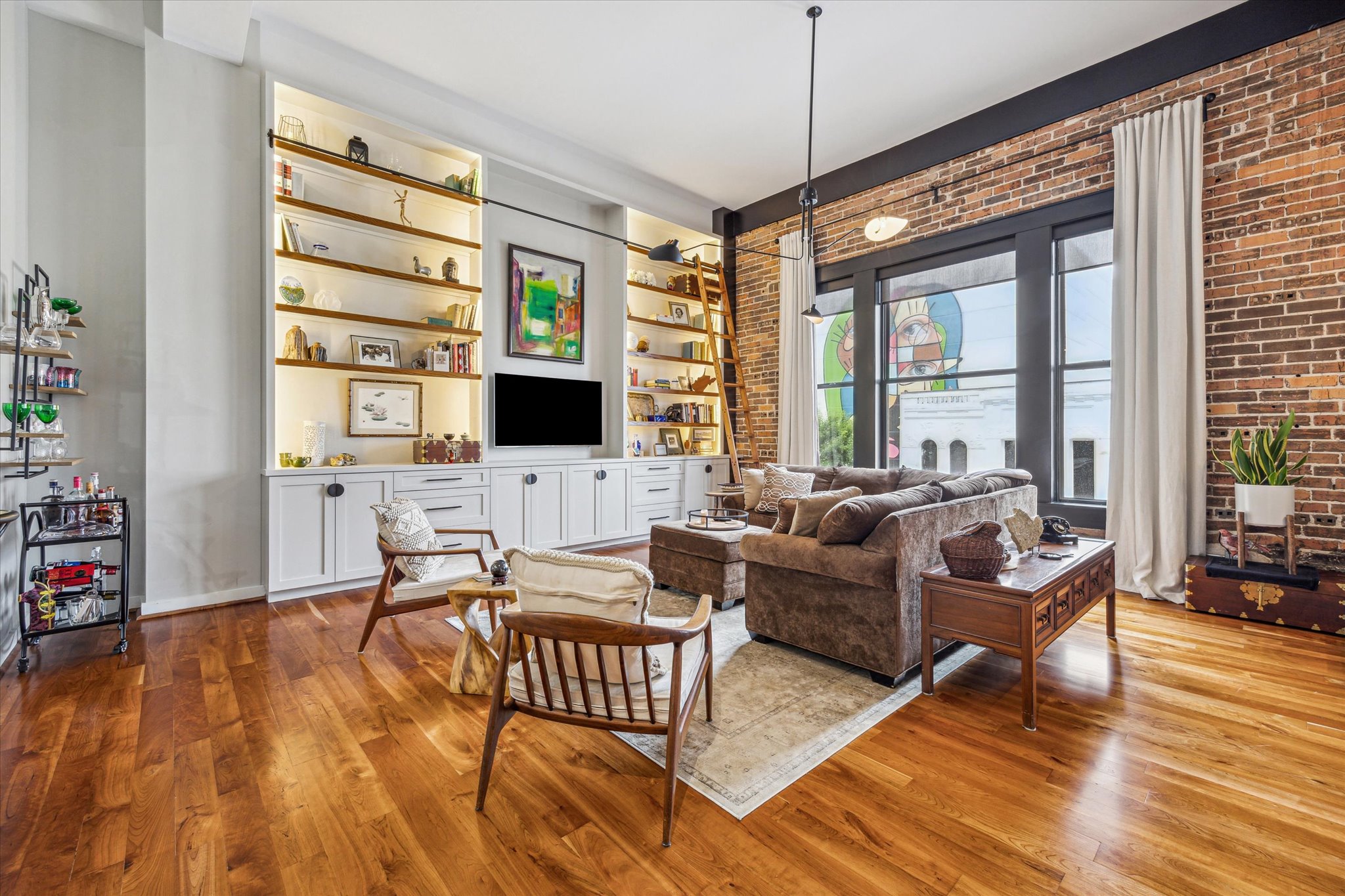 915 Franklin Street, Unit 2L 2L Houston, TX 77002 - Photo 4 of 11 a living room with furniture wooden floor and a flat screen tv