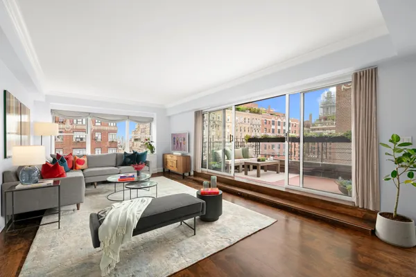 a living room with furniture and a floor to ceiling window