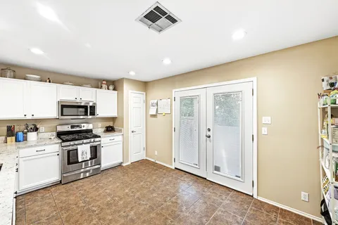 a kitchen with stainless steel appliances granite countertop a stove and a refrigerator