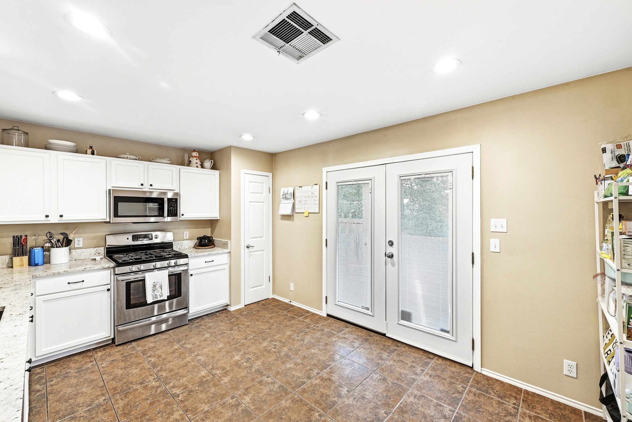 8901 Frock Court Austin, TX 78748 - Photo 16 of 28 a kitchen with stainless steel appliances granite countertop a stove and a refrigerator