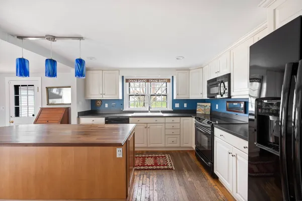 a kitchen with stainless steel appliances granite countertop a stove a sink dishwasher and a refrigerator