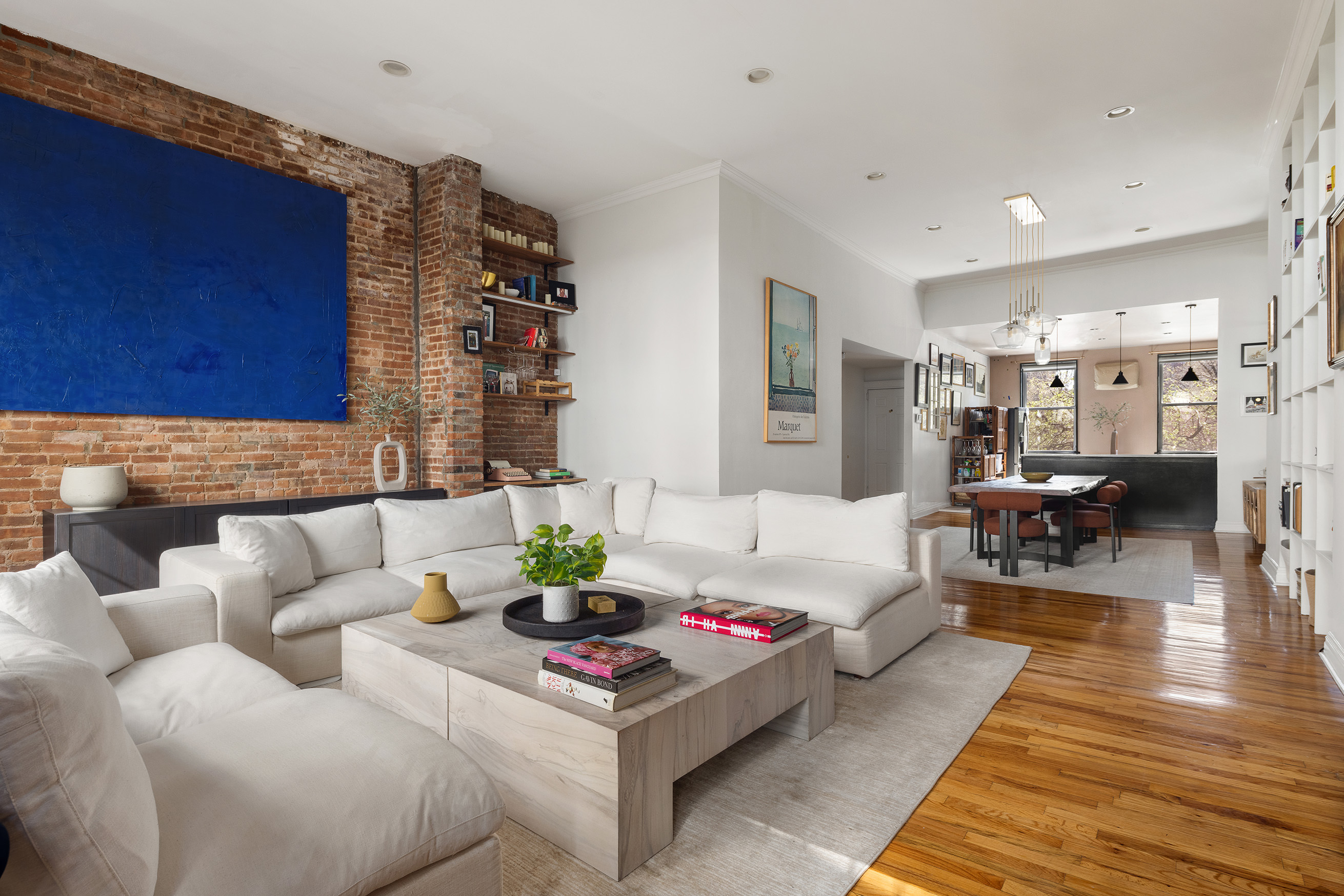 a living room with furniture and wooden floor