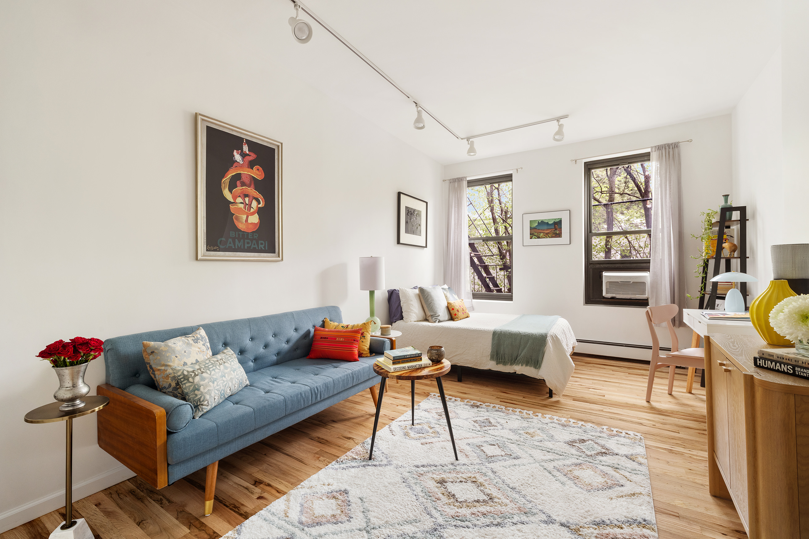 a living room with furniture and painting on the wall