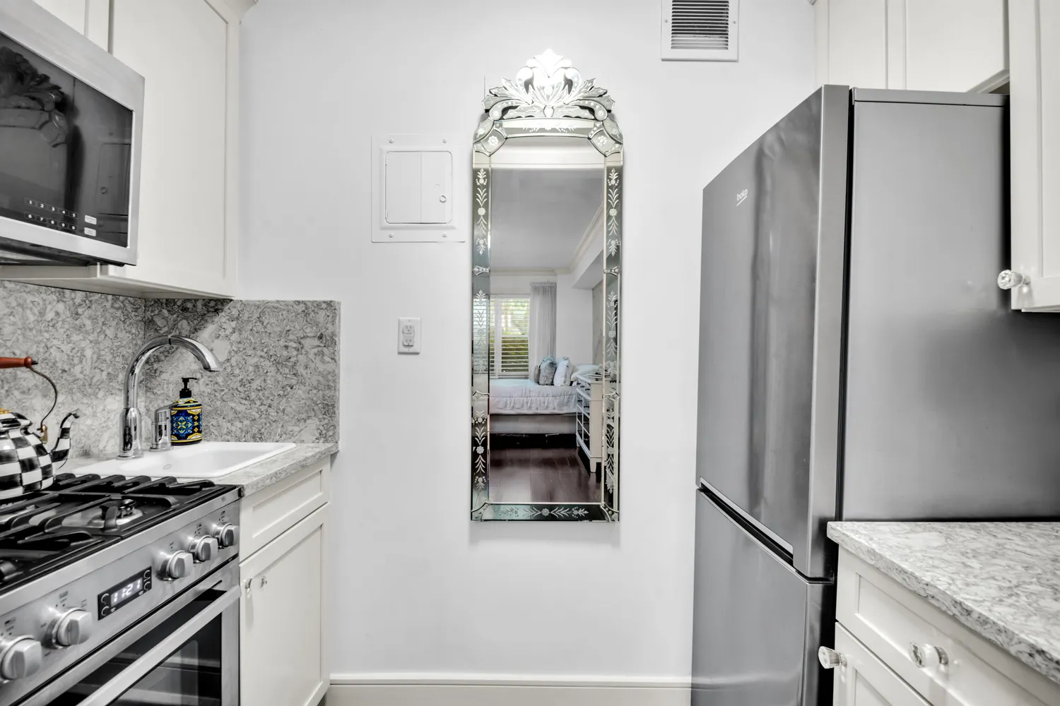 a kitchen with stainless steel appliances granite countertop a refrigerator and a stove