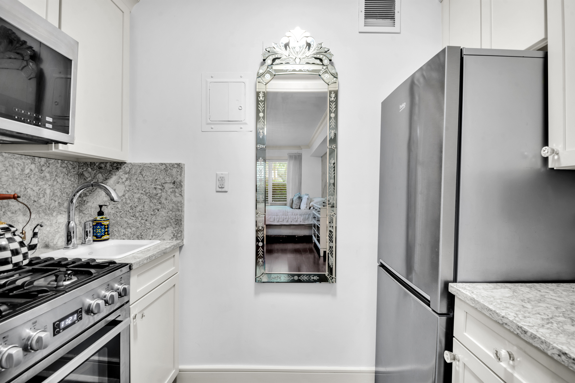 310 East 49th Street, Unit 1E Manhattan, NY 10017 - Photo 4 of 11 a kitchen with stainless steel appliances granite countertop a refrigerator and a stove