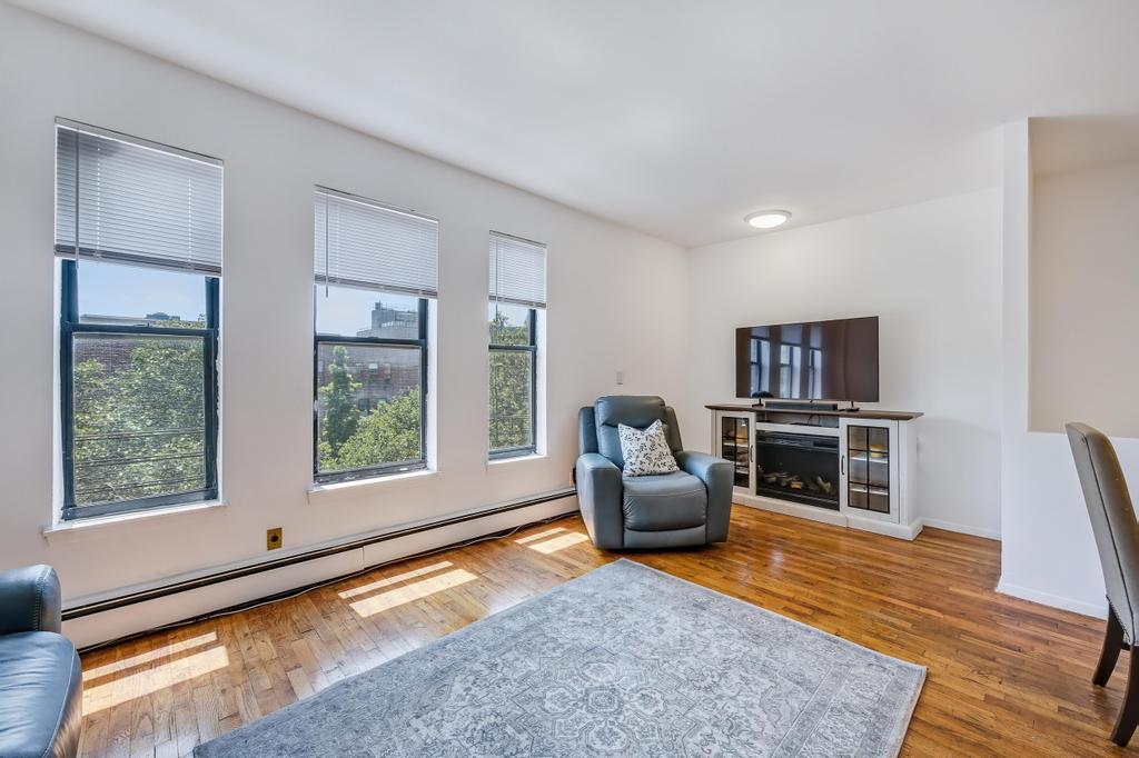 57 Carroll Street, Unit 38A Brooklyn, NY 11231 - Photo 9 of 21 a living room with furniture and a flat screen tv