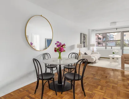 a view of a dining room with furniture and a large window
