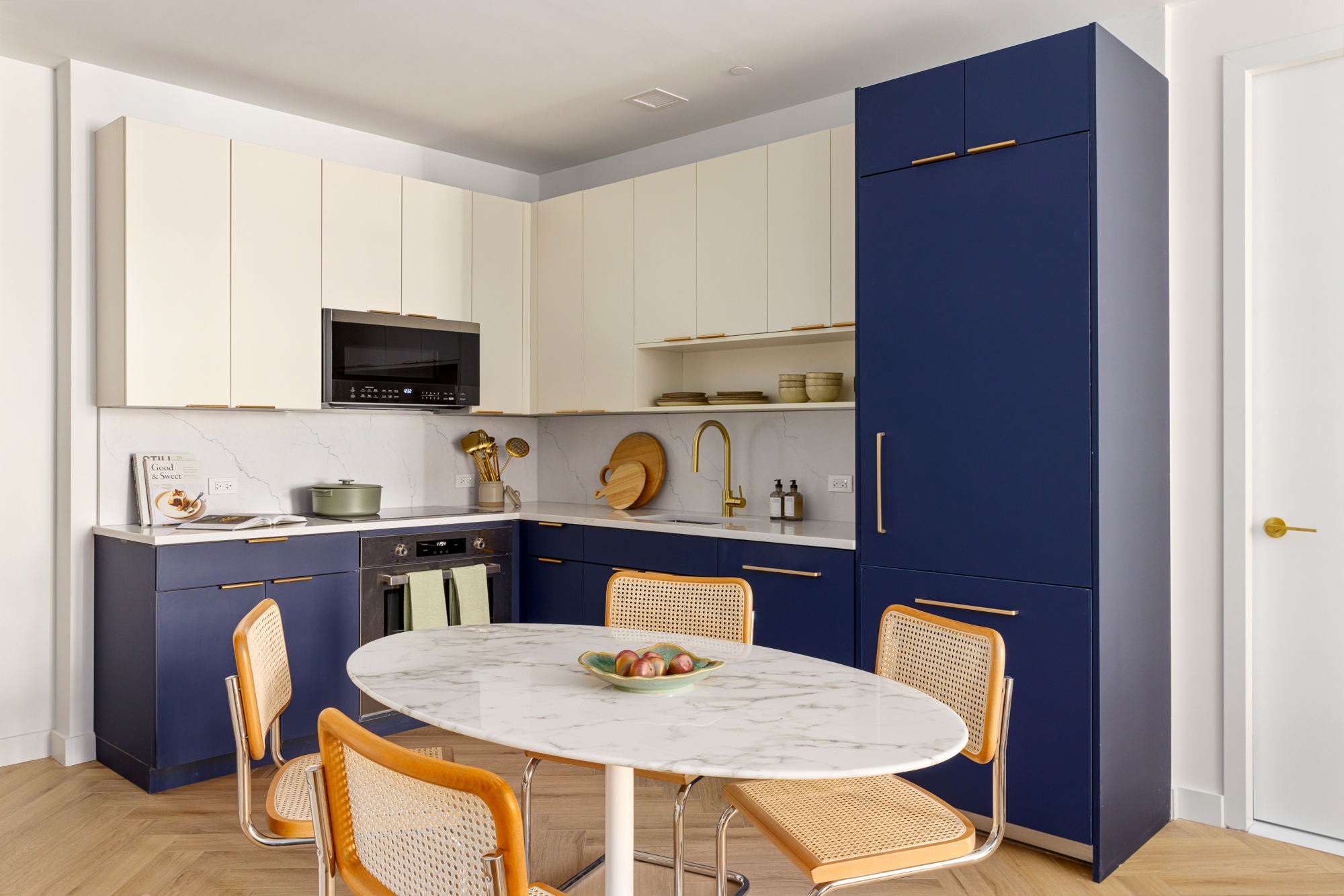 980 6th Avenue, Unit 412 Manhattan, NY 10018 - Photo 1 of 21 a kitchen with a table and chairs in it