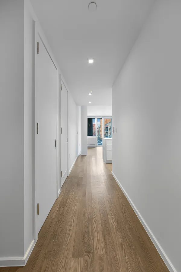 a view of a living room hardwood floor and a kitchen