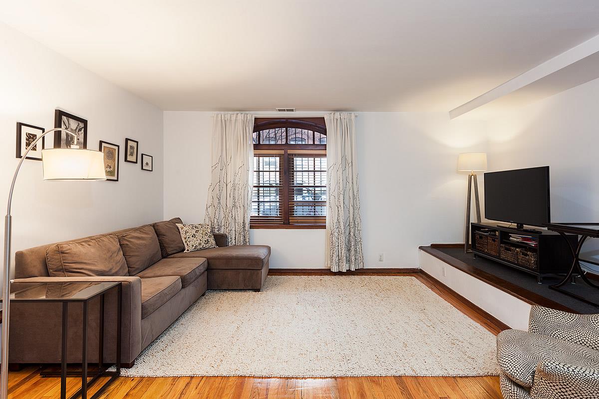 404 13th Street, Unit 1 Brooklyn, NY 11215 - Photo 1 of 7 a living room with furniture and a flat screen tv