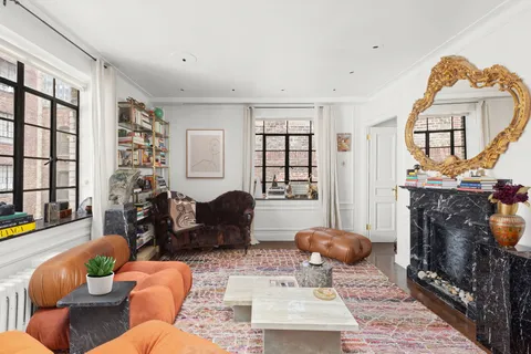 a living room with furniture a rug and a fireplace
