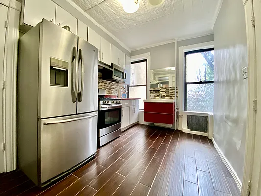 254 Wyckoff Street, Unit 2L Brooklyn, NY 11217 - Photo 4 of 8 a kitchen with stainless steel appliances a refrigerator and a stove top oven