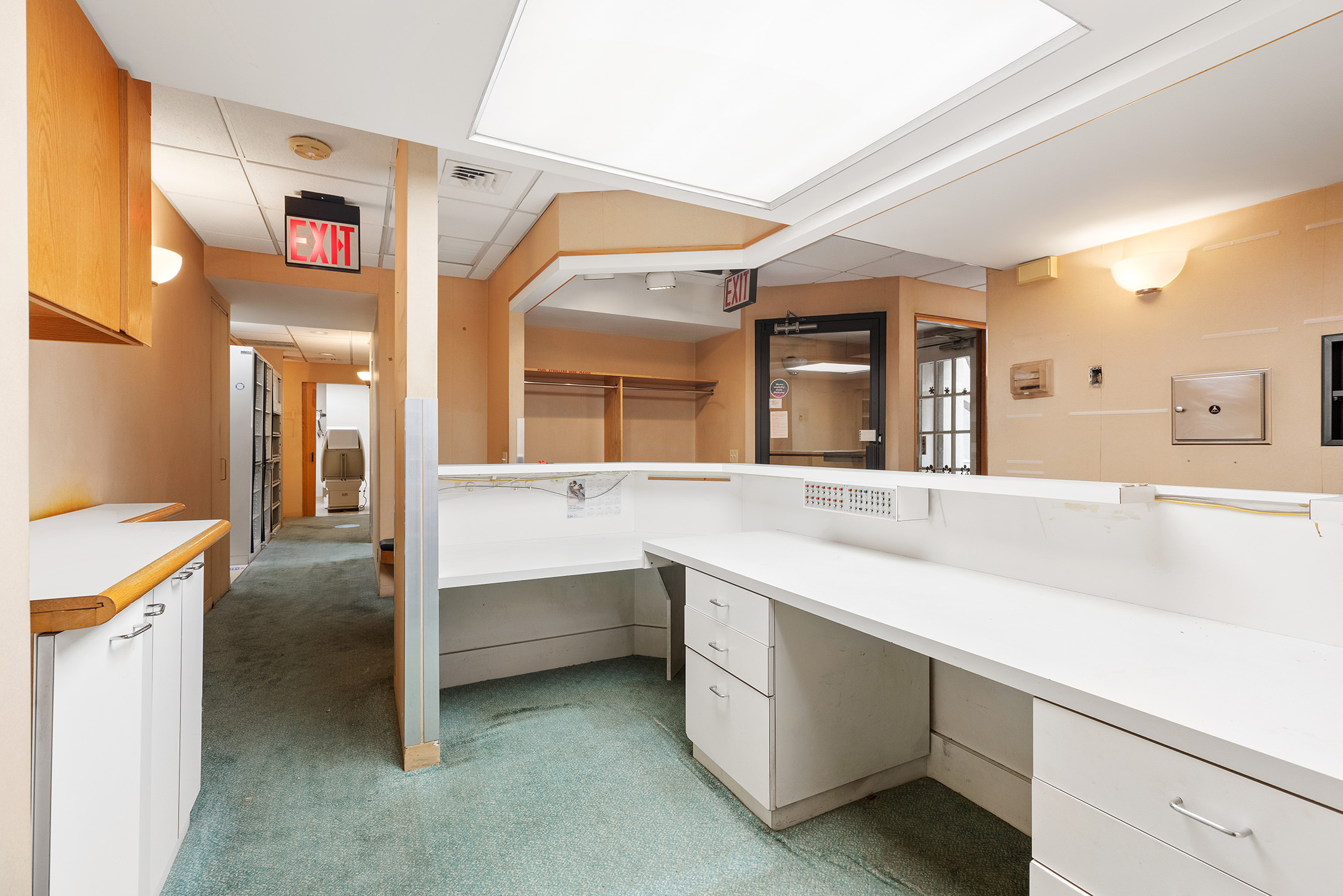 47 East 88th Street Manhattan, NY 10128 - Photo 9 of 11 a hallway with cabinets a sink and a large window