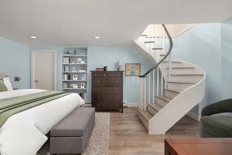 a room with a bed and a chandelier