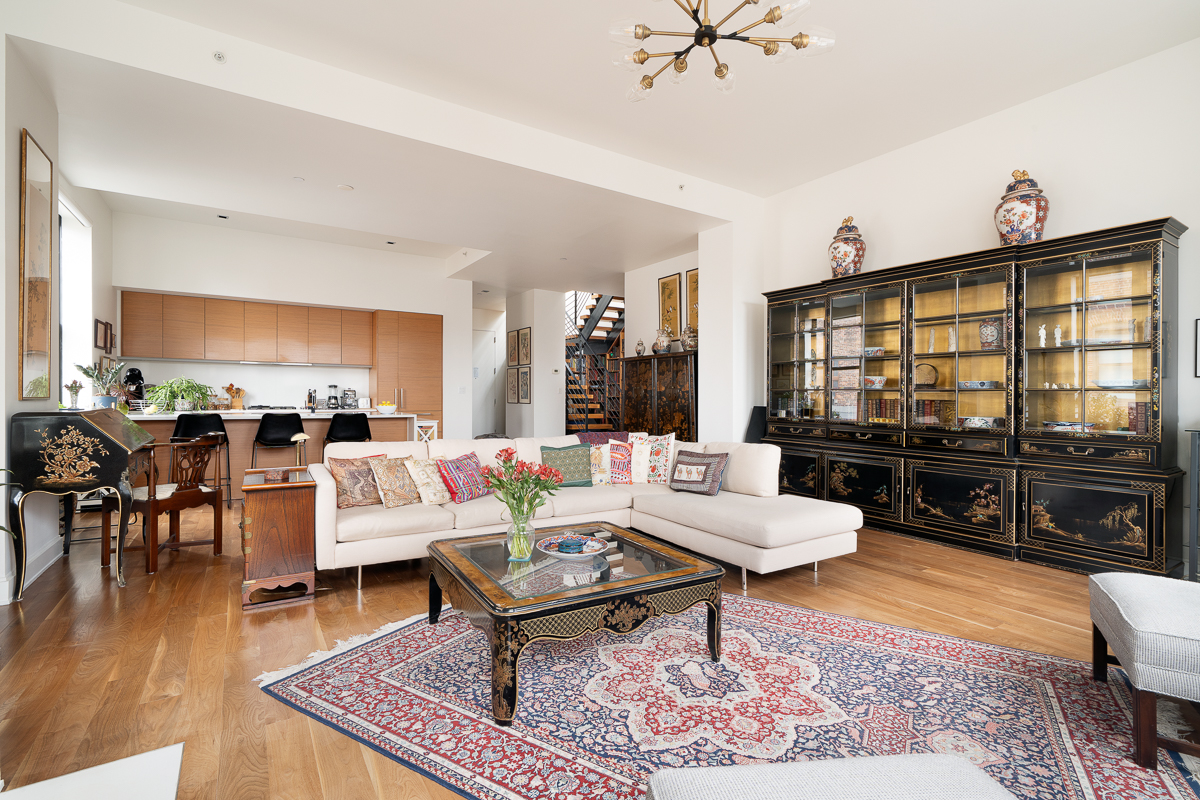 140 West 22nd Street, Unit PHC Manhattan, NY 10011 - Photo 2 of 15 a living room with furniture a rug and a table