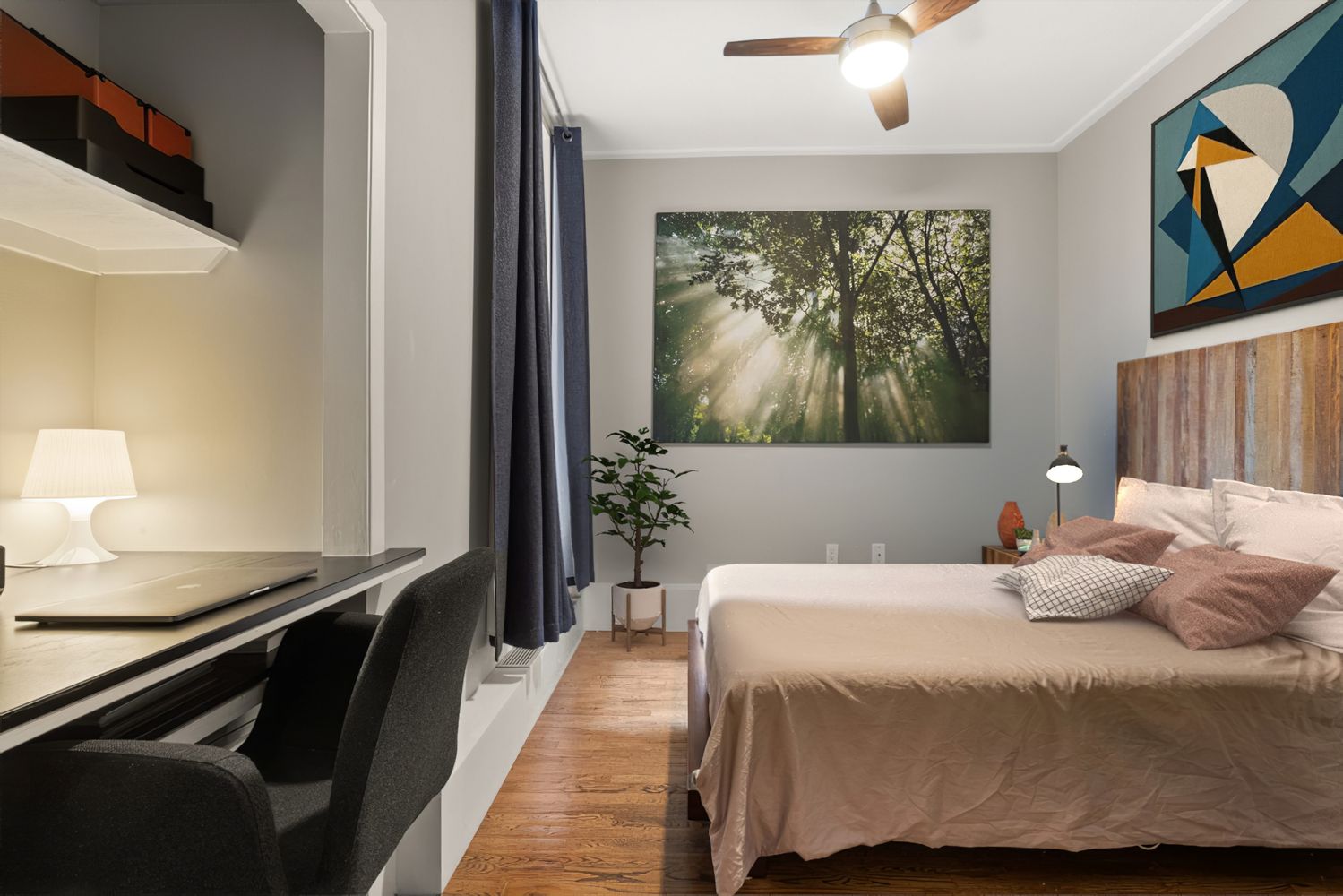 a bedroom with a bed and a painting on the wall