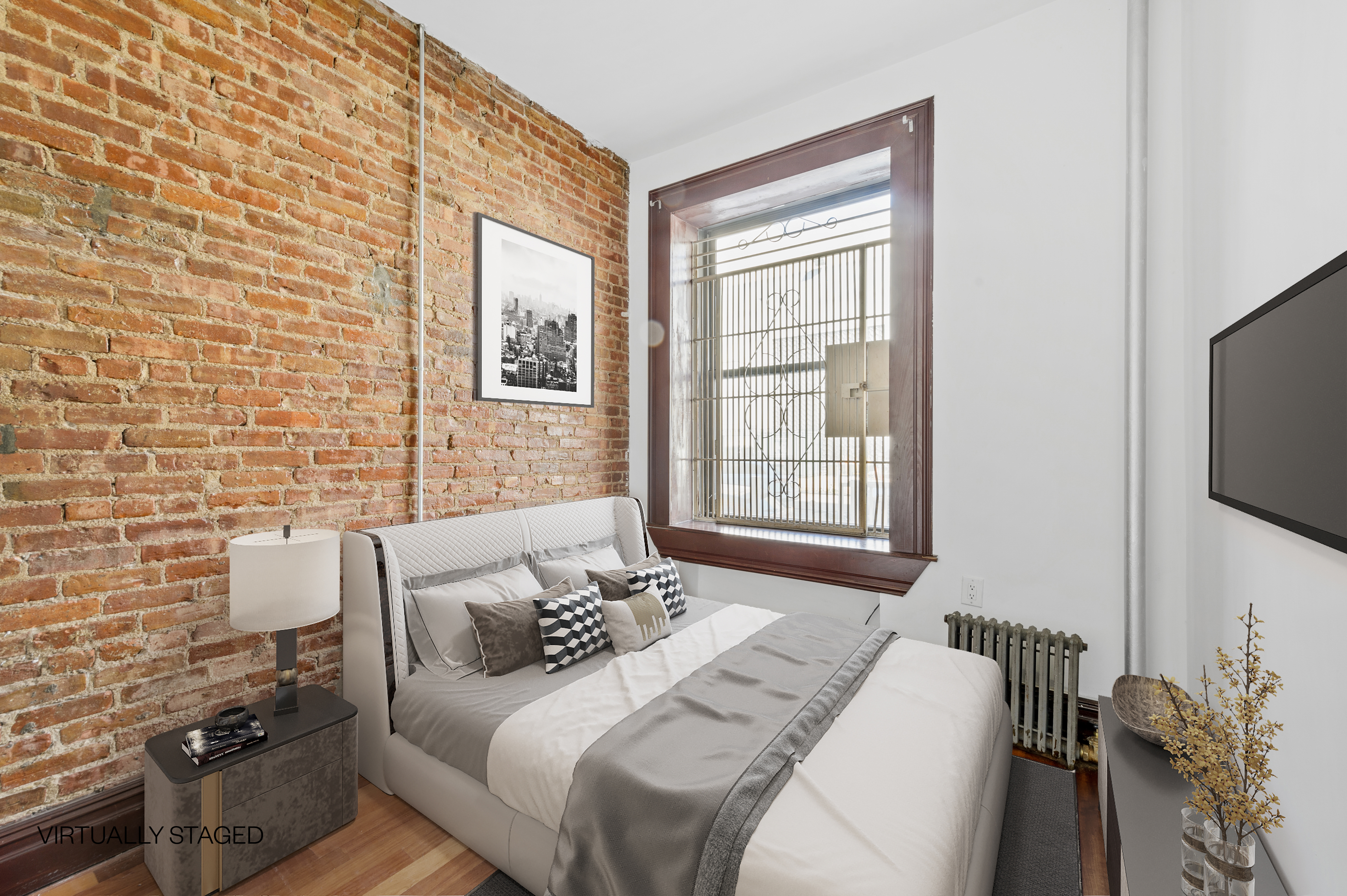 144 West 109th Street, Unit 1W Manhattan, NY 10025 - Photo 3 of 5 a bedroom with a bed and a flat screen tv