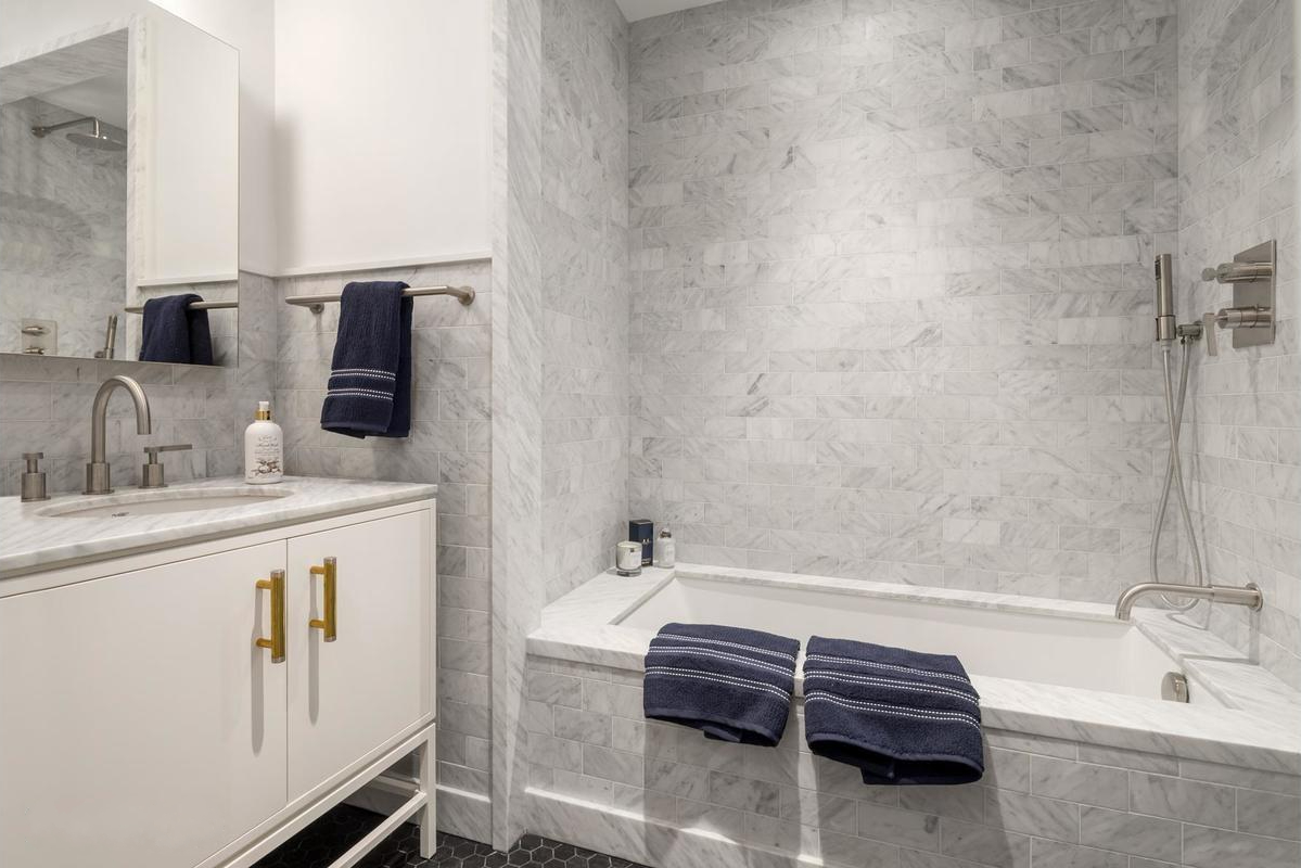 275 West 10th Street, Unit 3B Manhattan, NY 10014 - Photo 10 of 20 a bathroom with a tub sink and mirror