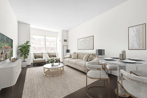 a living room with furniture wooden floor and a large window