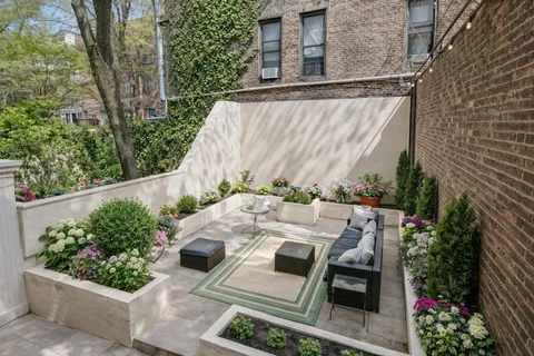 a view of a patio with table and chairs and potted plants