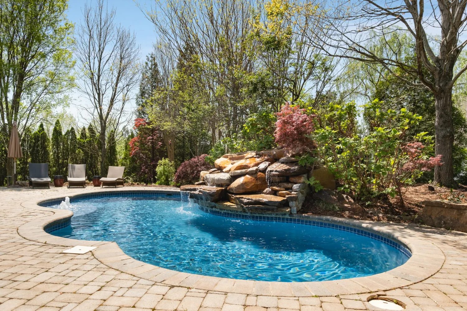a view of a swimming pool with a yard