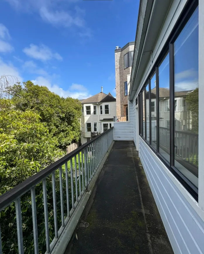 a view of a big room with windows and chandelier