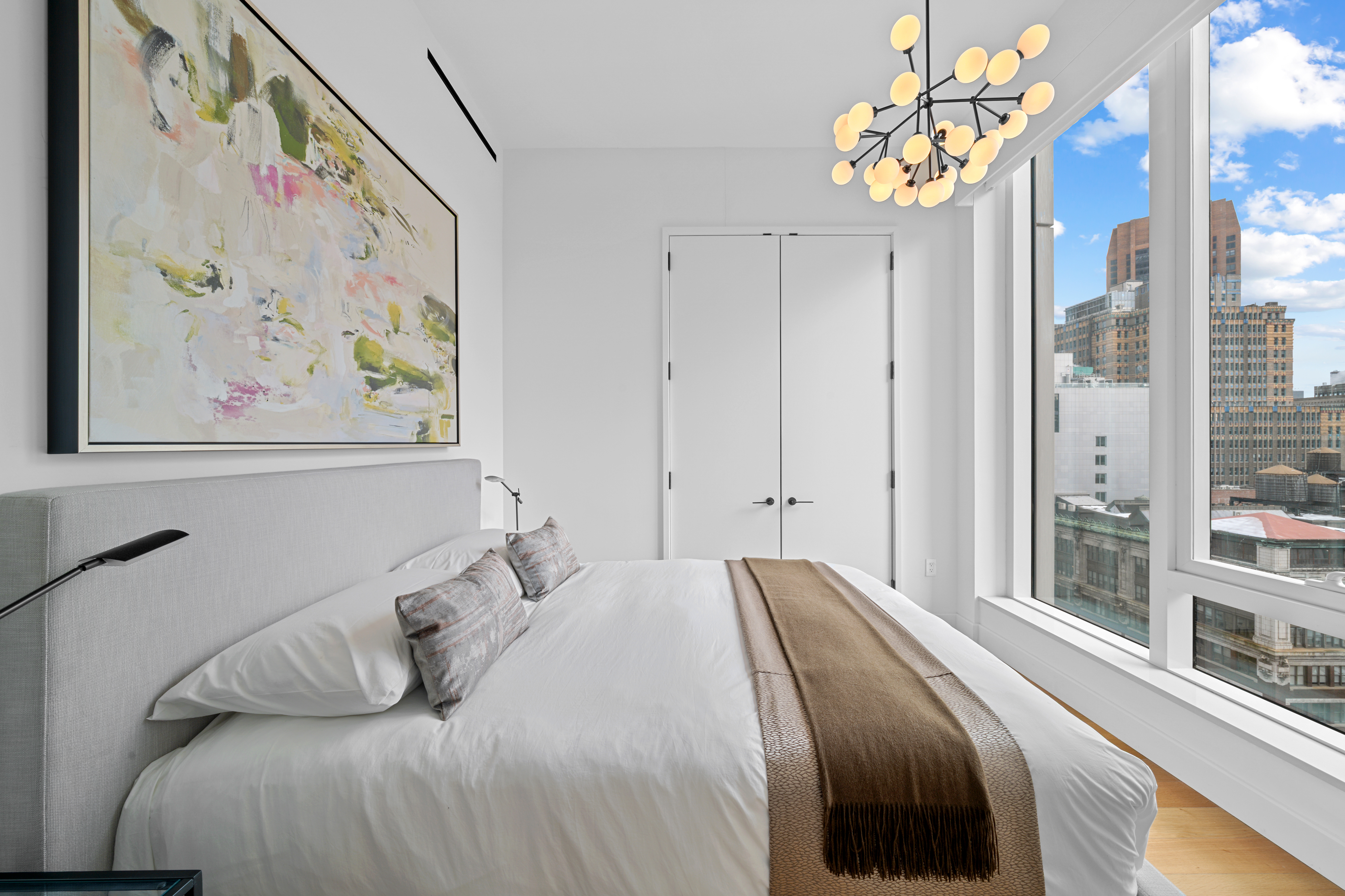 15 East 30th Street, Unit 19B Manhattan, NY 10016 - Photo 24 of 40 a bedroom with a bed and a painting on the wall