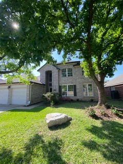 a view of a backyard with a garden and trees