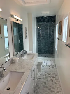 a bathroom with a tub sink and mirror