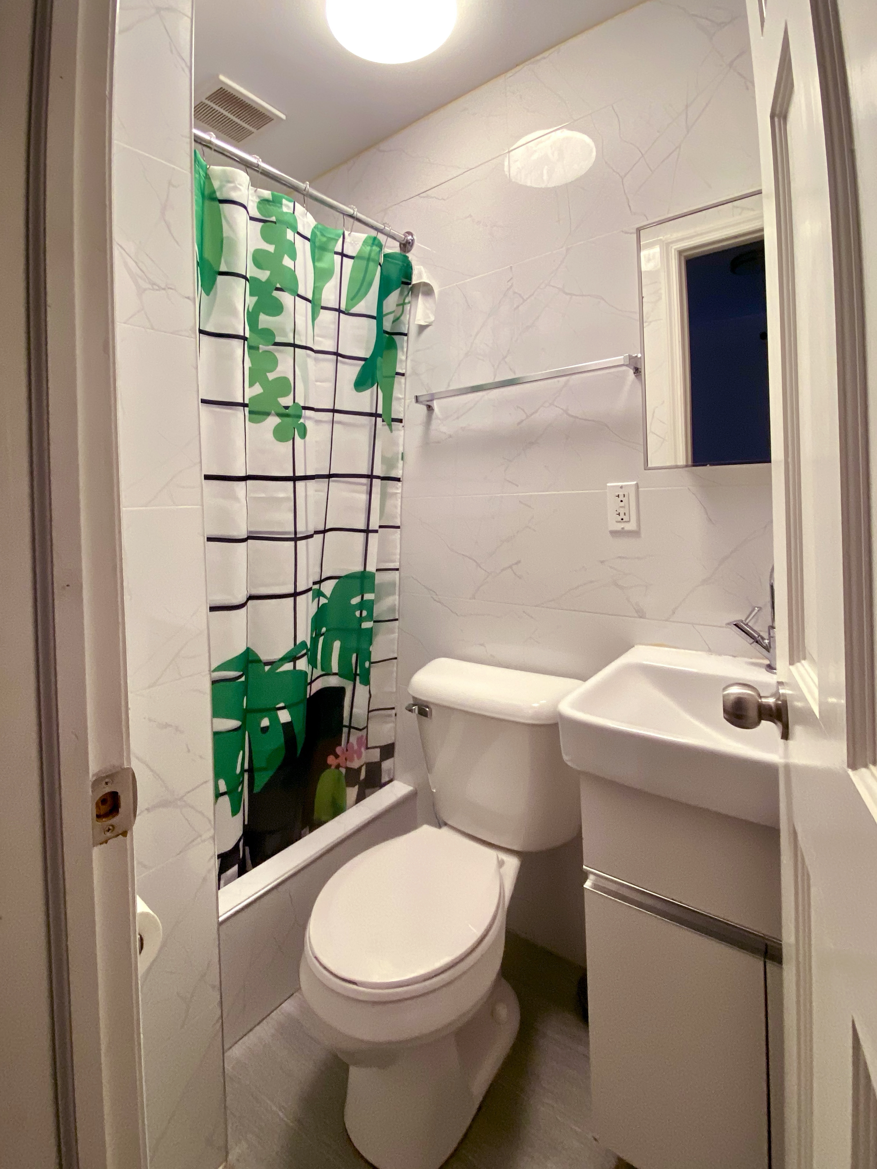40 East Broadway, Unit 5 Manhattan, NY 10002 - Photo 7 of 10 a bathroom with a sink and mirror with toilet