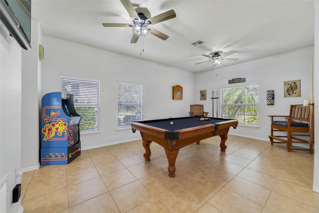 352 Giovani Boulevard Clermont, FL 34715 - Photo 8 of 46 a room with pool table and windows