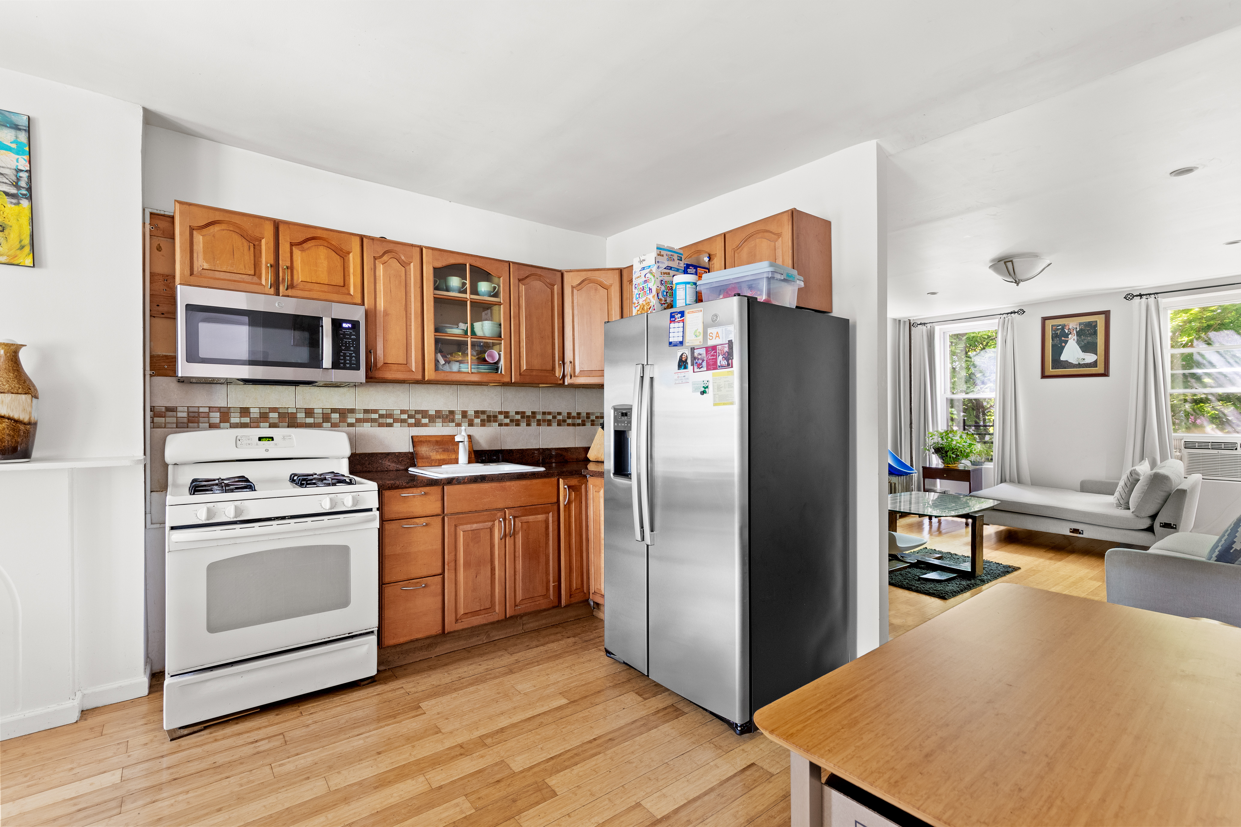 300 Gates Avenue Brooklyn, NY 11216 - Photo 4 of 13 a kitchen with stainless steel appliances granite countertop a refrigerator stove and a sink