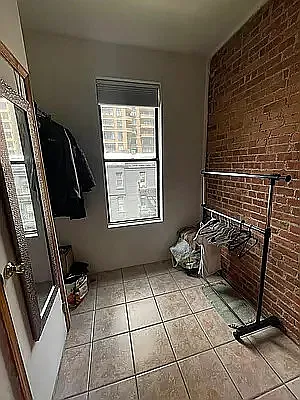 402 East 69th Street, Unit 28 Manhattan, NY 10065 - Photo 3 of 5 a bedroom with a bed and a window