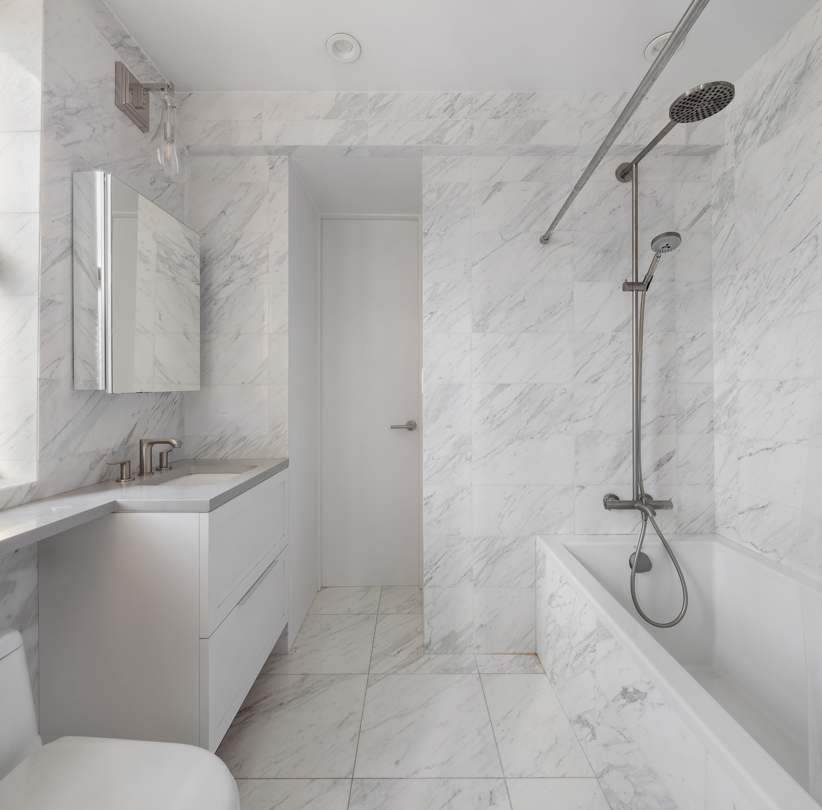 26 East 10th Street, Unit 11G Manhattan, NY 10003 - Photo 12 of 14 a bathroom with a sink toilet and shower