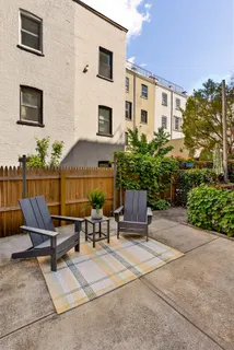 a view of a backyard with chairs