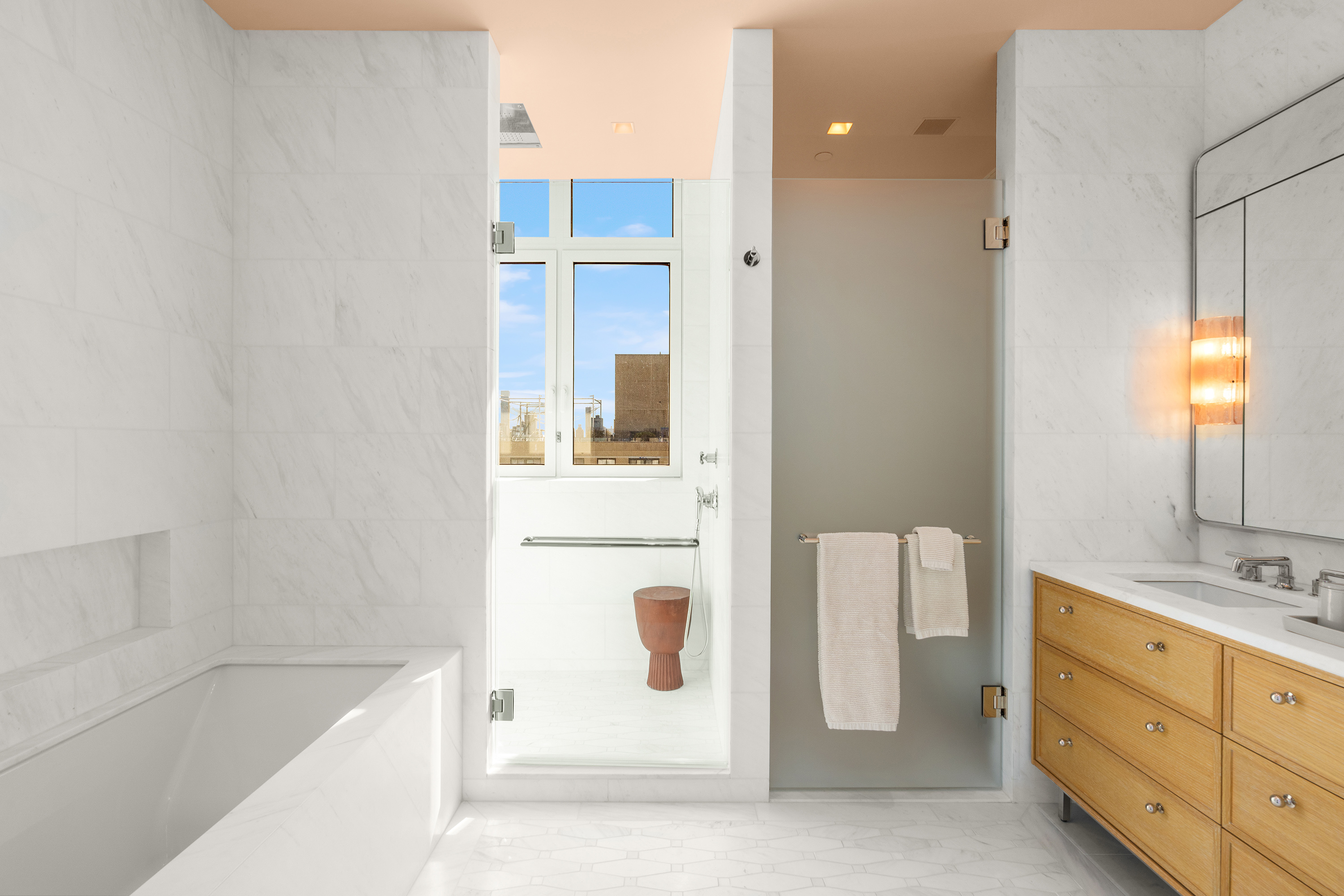 200 East 83rd Street, Unit 24C Manhattan, NY 10028 - Photo 12 of 35 a bathroom with a tub sink and mirror
