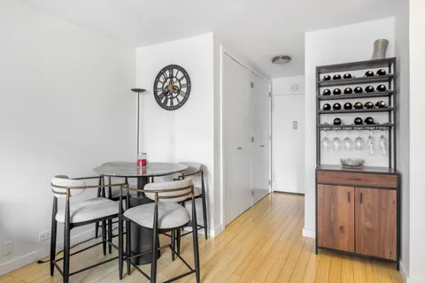 a view of a hallway with entryway wooden floor and front door