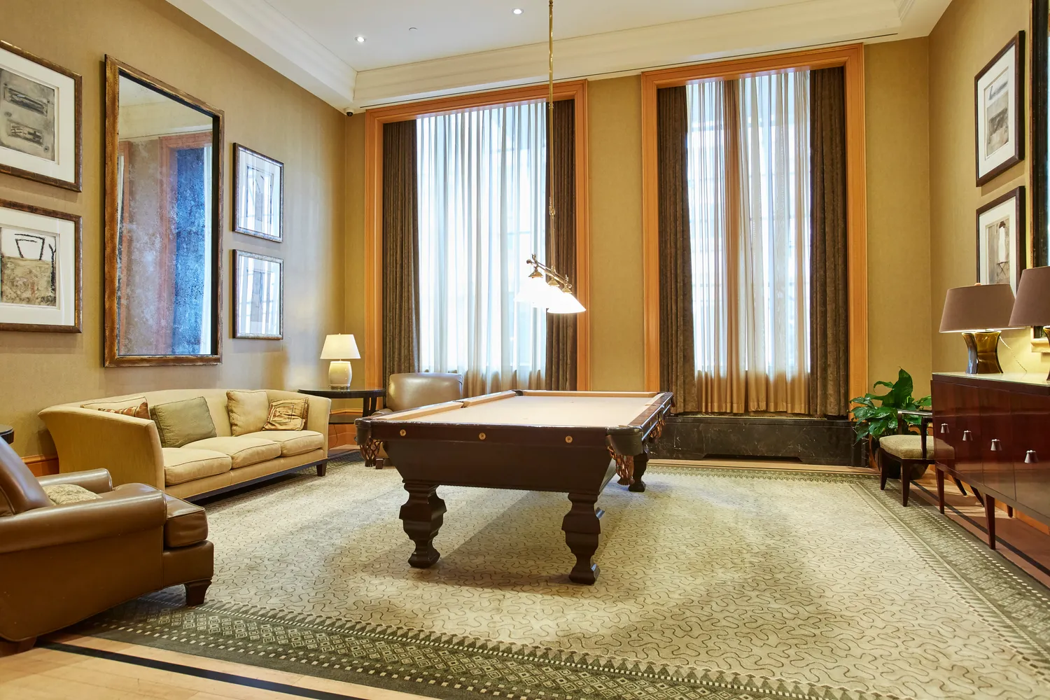 a living room with furniture and large windows