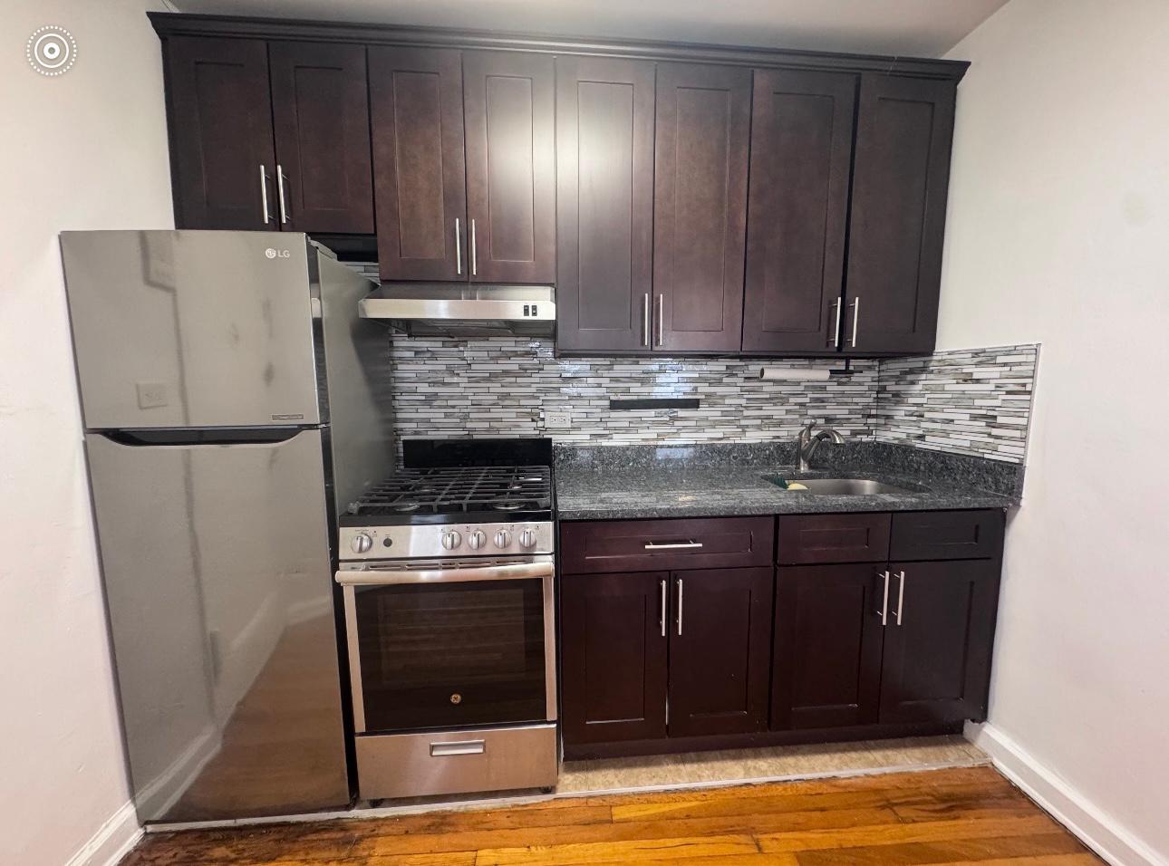 123 Avenue A, Unit 4 Manhattan, NY 10009 - Photo 5 of 14 a kitchen with a refrigerator and cabinets