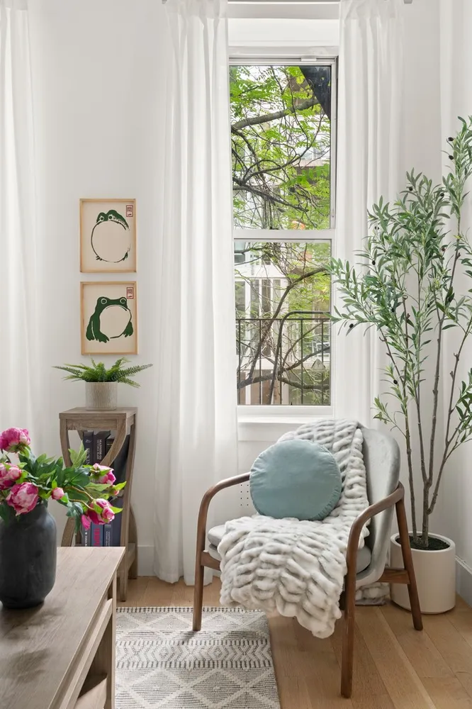 a living room with furniture and a potted plant
