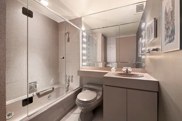 a bathroom with a sink toilet and shower