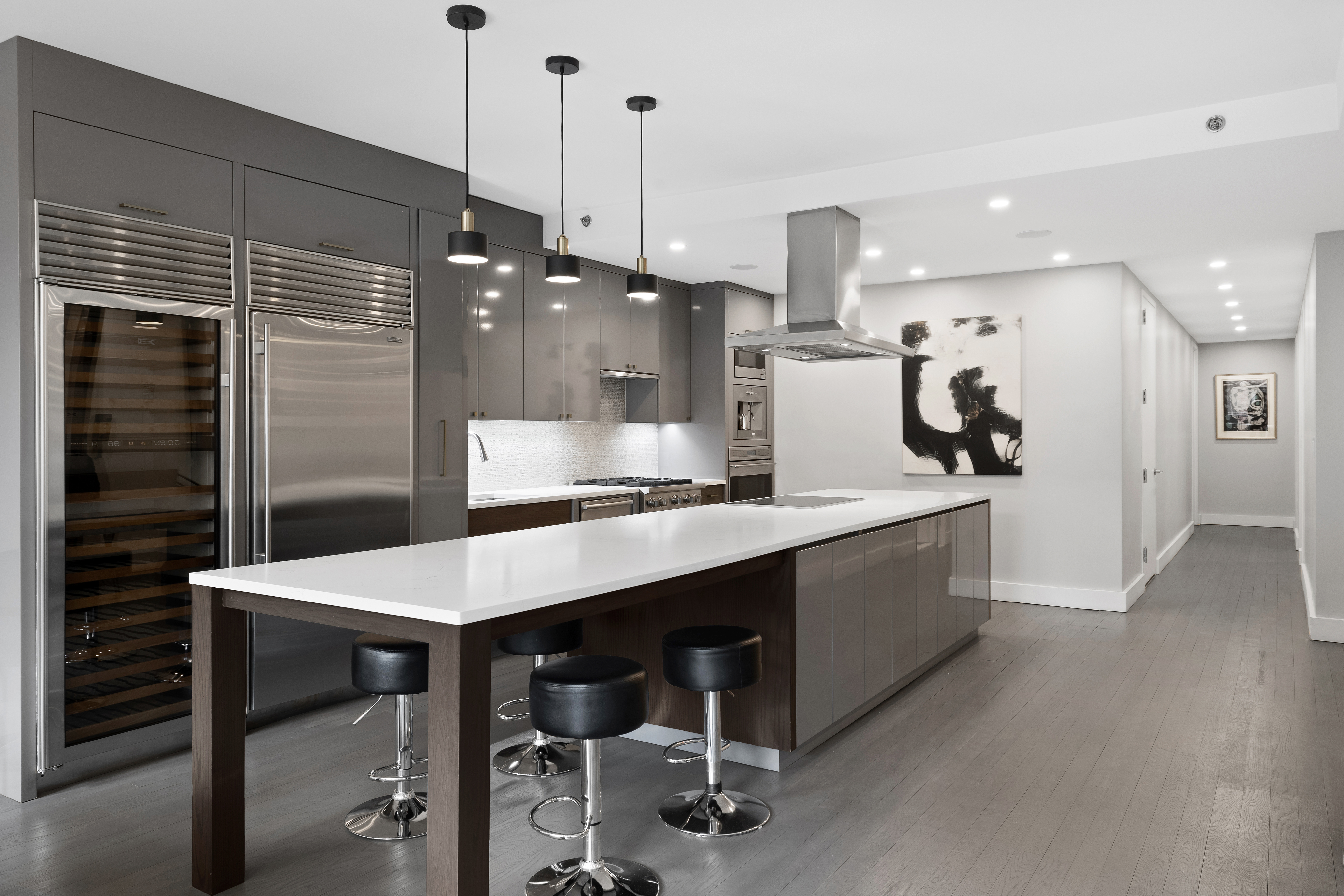 129 West 123rd Street, Unit 3 Manhattan, NY 10027 - Photo 5 of 20 a kitchen with a table chairs refrigerator and microwave